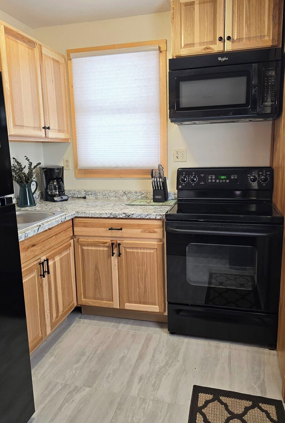 Kitchen has been remodeled with new cabinets and countertops.