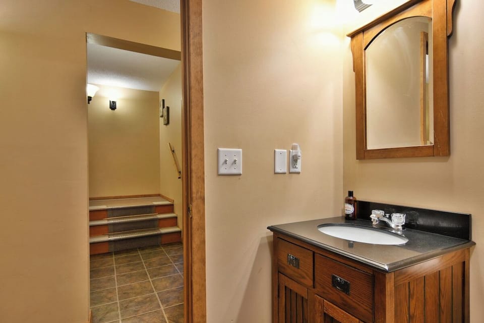 Bathroom 2 is located at the bottoms of the stairs on the lower level