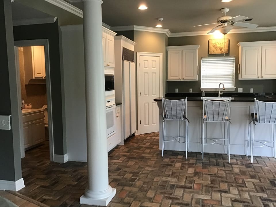 View of kitchen and restroom off den