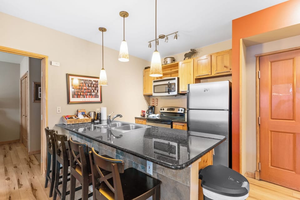 Your fully-equipped kitchen features granite counters, stainless appliances, and breakfast bar seating where you can enjoy morning coffee or casual meals together.