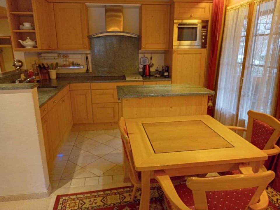 the open kitchen with a small island and a dinning table 