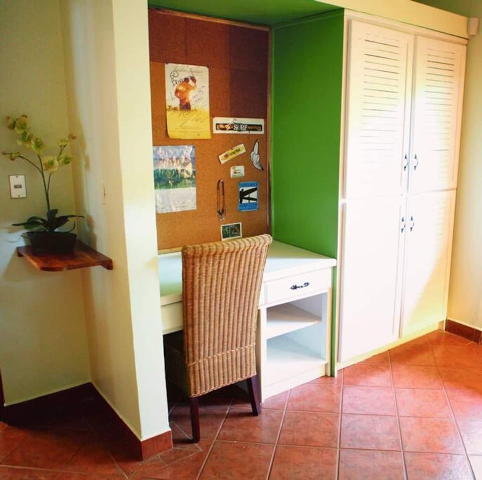 Functional workspace with a comfortable desk and chair, ideal for remote work or planning your Tamarindo adventures, combining productivity with a relaxing vacation environment.