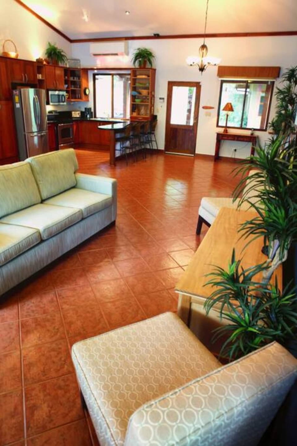 Bright and airy common areas filled with natural light and lush greenery, creating a refreshing and inviting atmosphere throughout your Tamarindo vacation home.