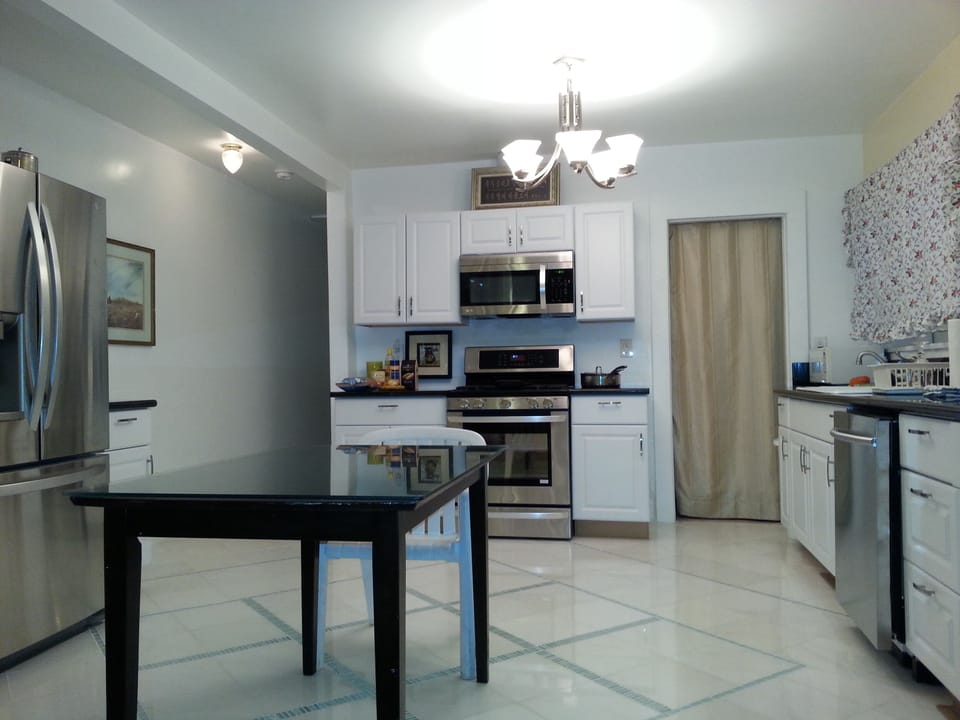 Chef's Kitchen, fully equipped with all new appliances! Laundry room behind.