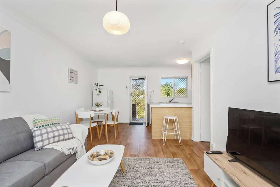 Step into a modern and inviting space! Our open-concept living area, featuring a comfortable lounge, dining nook, and practical kitchen, offers everything you need.