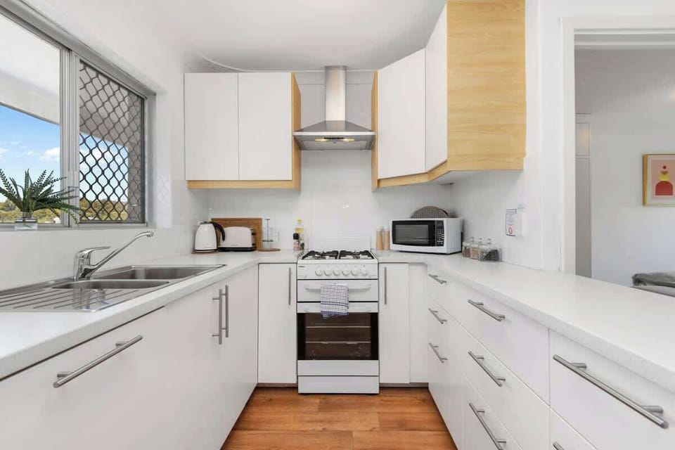 Enjoy the convenience of a fully functional area for all your culinary needs. Bright and ready for meal preparation, complete with various appliances and ample work surfaces