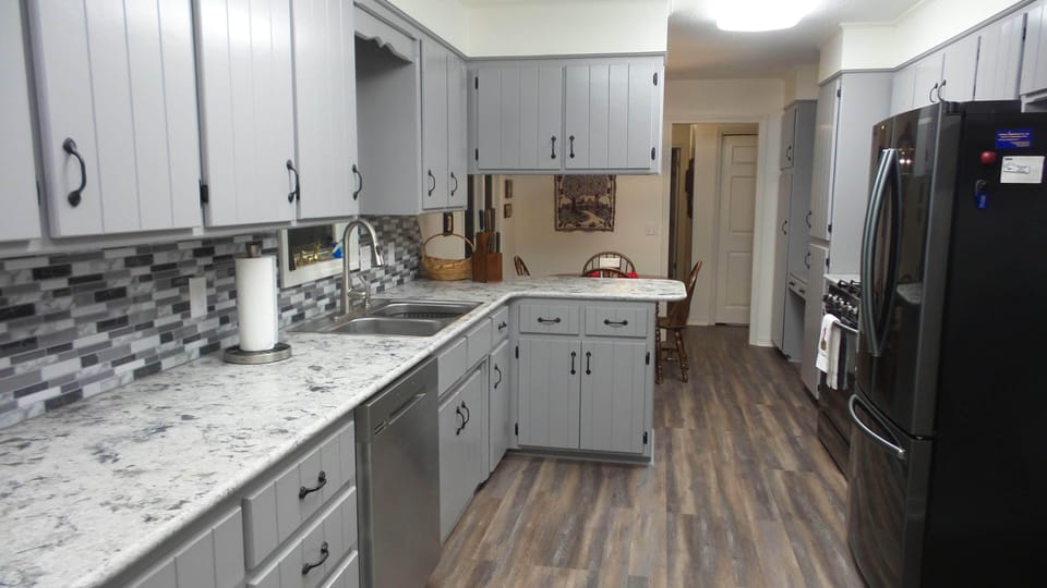 Kitchen from garage door looking towards dinette and entry hall.