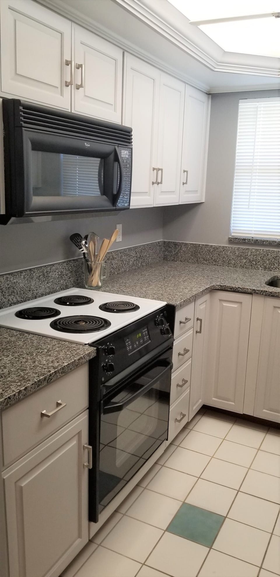 Newly updated kitchen fully stocked with dishes, utensils, and cookware. 