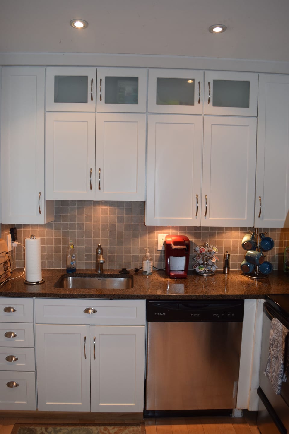 Kitchen is stocked with dishes, glasses, pots, pans, etc. 
