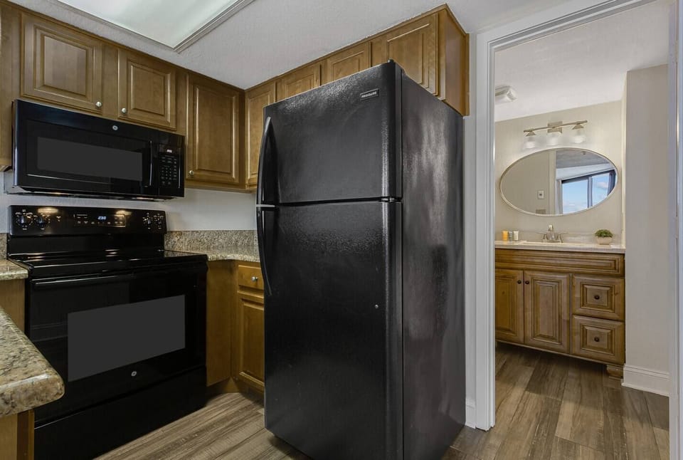 Discover modern elegance in every corner of our oceanview suite's kitchen, with high-end finishes, stainless steel appliances, and expansive windows framing the picturesque seascape.