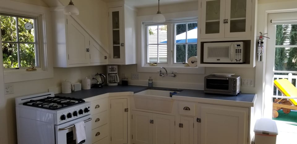 Kitchenette wih range, cookware, service, microwave,  toaster oven, griddle 