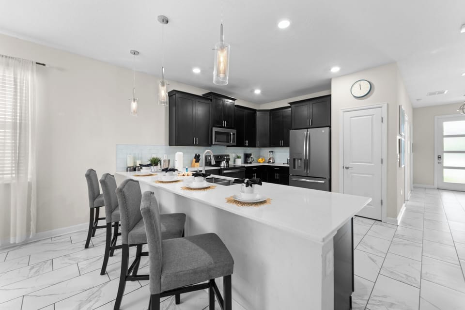 Step into a stylish, fully equipped kitchen where you can whip up your favorite meals at the spacious island, perfect for casual dining and morning coffee. Modern appliances and elegant cabinetry make cooking a joy.