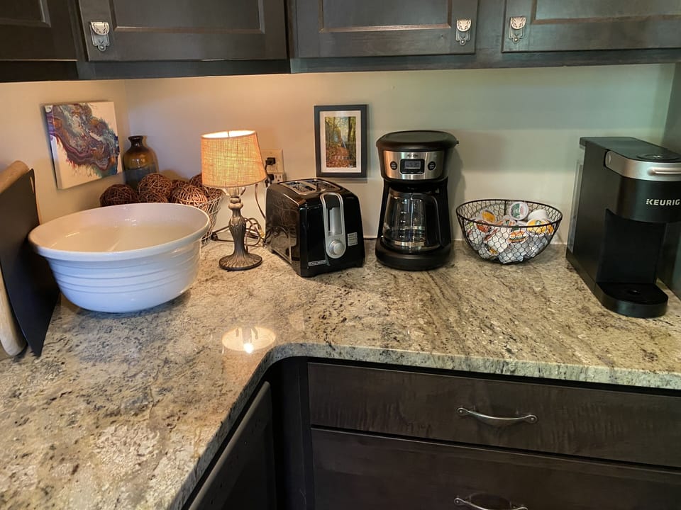 Coffee pot & Keurig with coffee & creamers provided.