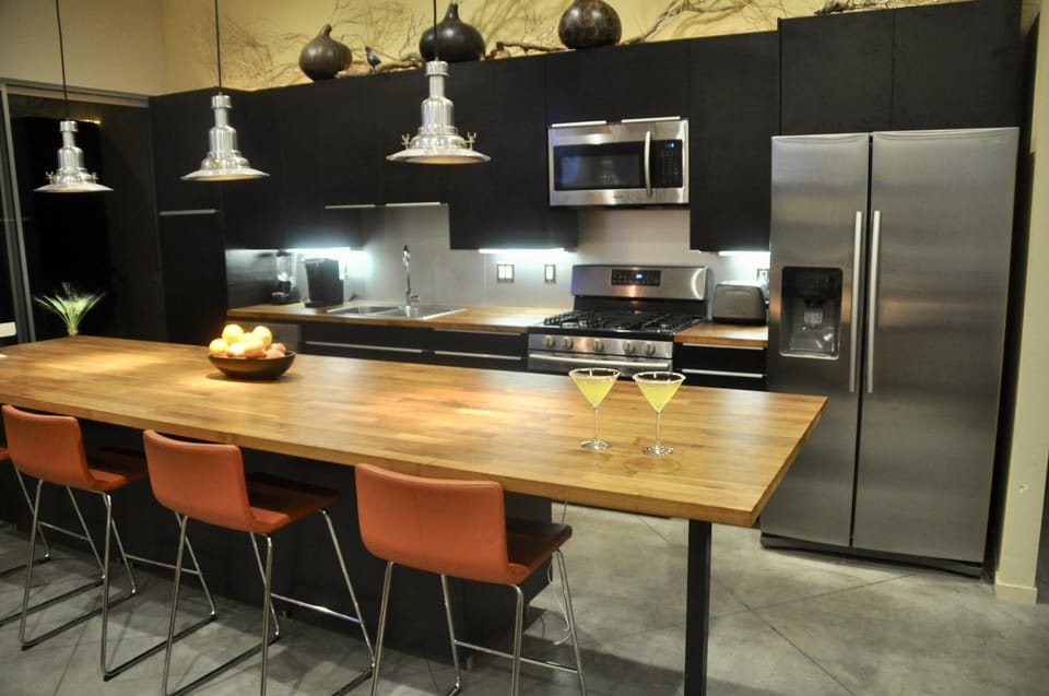 Kitchen with huge 12 foot long walnut counter and loads of kitchen equipment