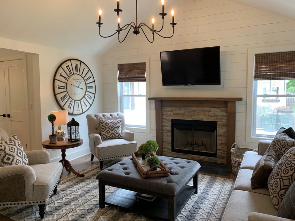 Stunning living room features wood burning fireplace, vaulted ceiling, smart tv