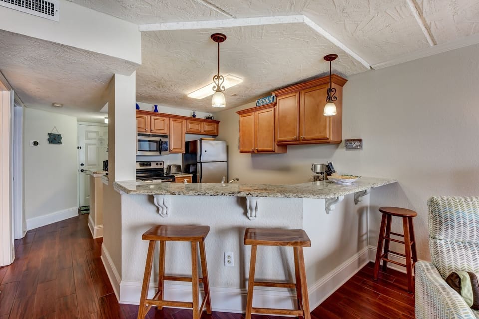 Kitchen with higher ceiling, providing a spacious feeling and view of the ocean