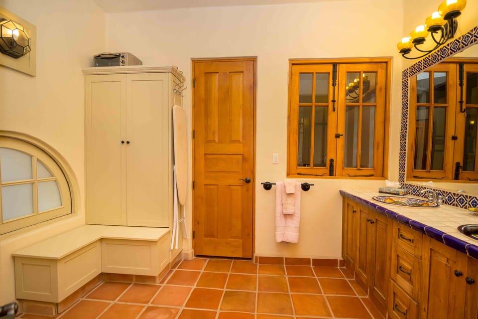 Downstairs Bathroom with Dresser, Vanity mirror, towels hair dryer