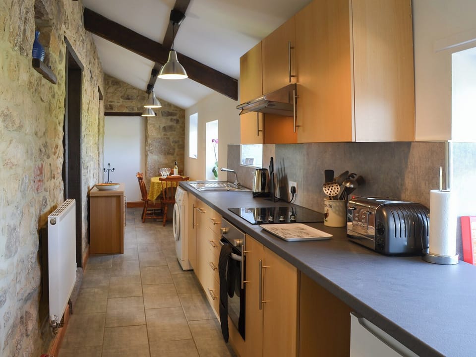 Tile-floored galley style kitchen | Mains Cottage, Belford, near Bamburgh