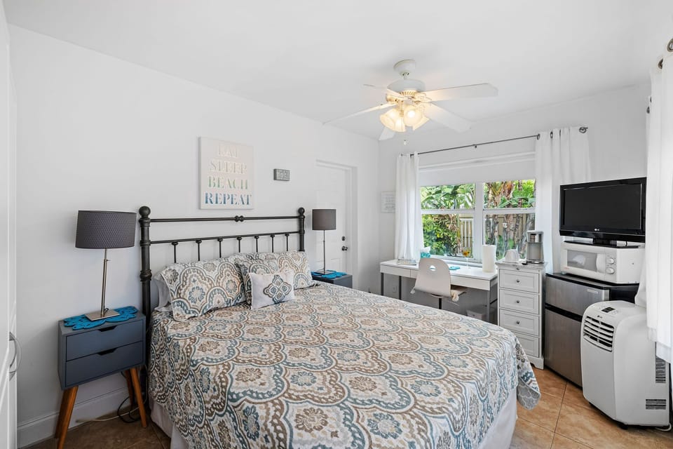 Bedroom with queen bed and work space.