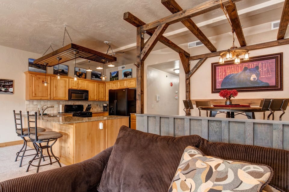 Foxpoint 1684-H3: Cozy sofa set, dining table, with a glimpse of the kitchen.