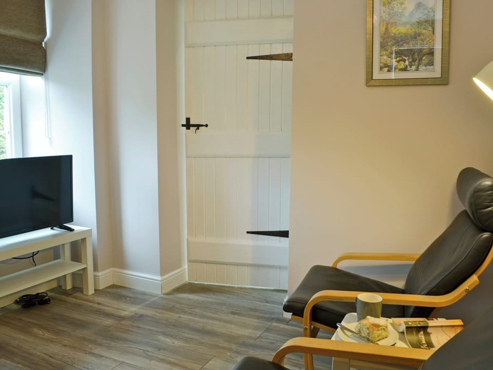 Inviting dining room with woodburner and seating area | Altbeg, Isle of Arran