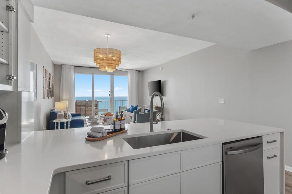Beachfront condo with open living + dining—seamless views, sunlit vibes.