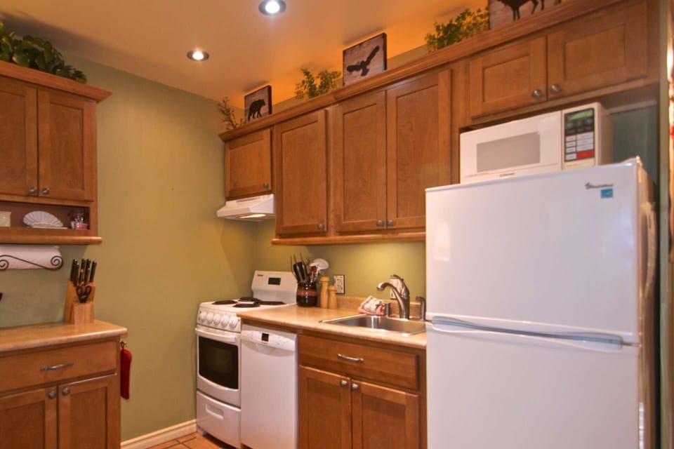 Stove, dishwasher, microwave and fridge and cookware ready for you to prepare your meals
