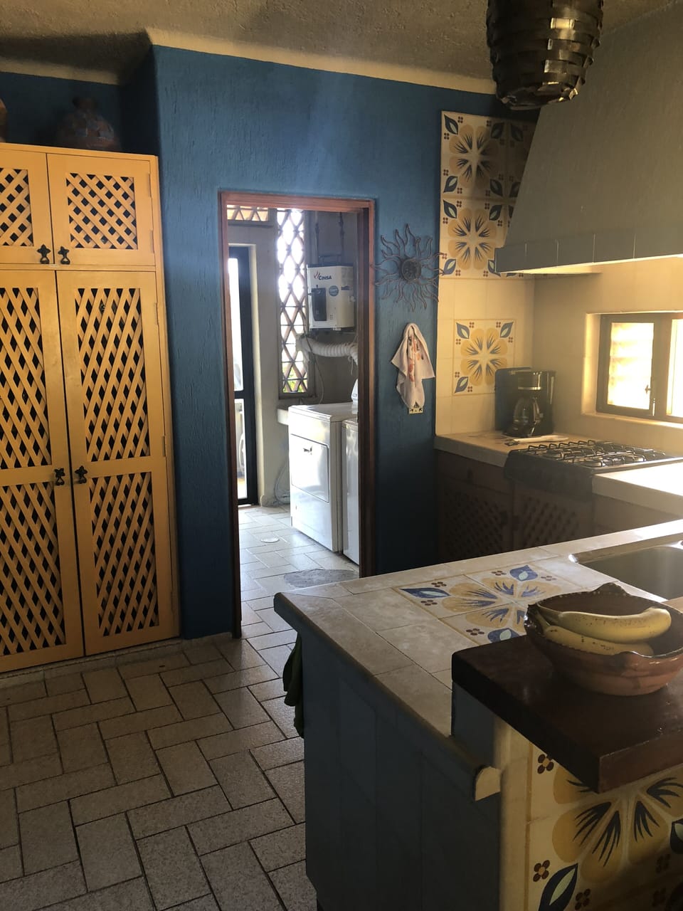 Entrance to laundry room & second terrace complete with BBQ.