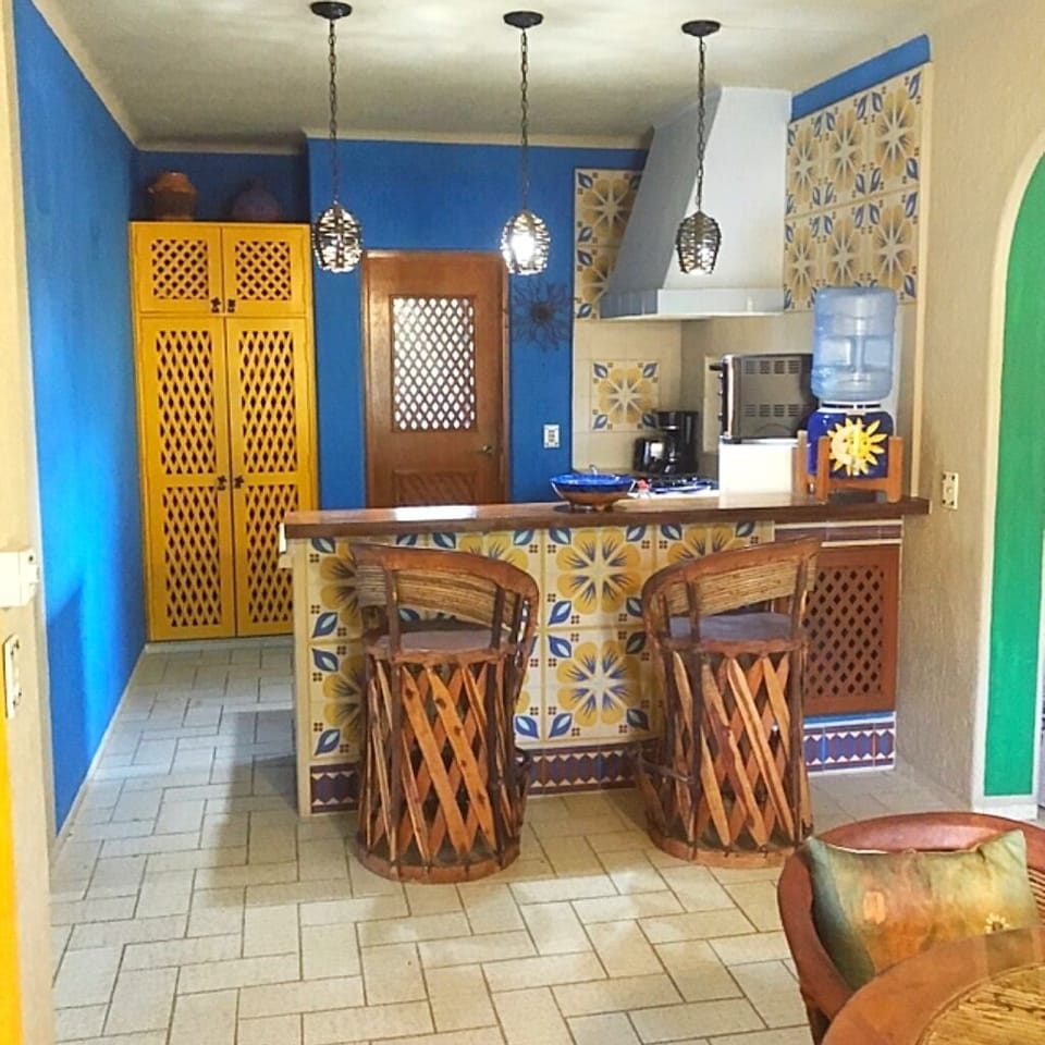 Colorful full functioning kitchen with stove & refrigerator.