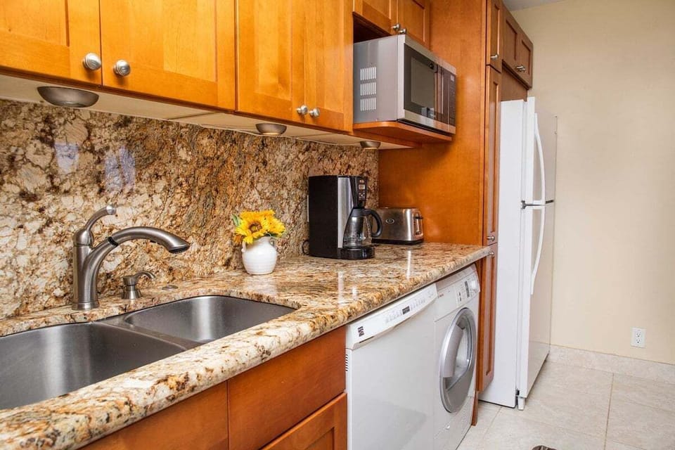 Cook in modern kitchens framed by granite, wood, and island ease.