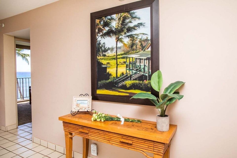 Pause at entry tables styled with tropical art and island touches.