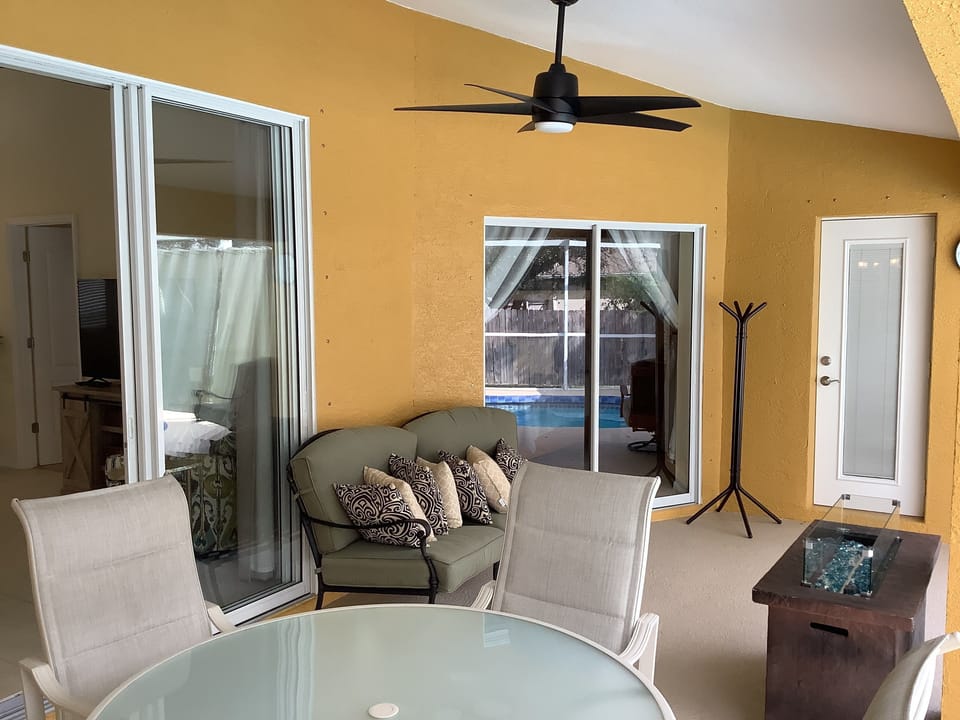 The lanai has dining and relaxing seating spaces/areas.
