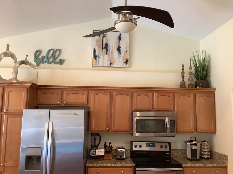 Spacious, kitchen with stainless steel appliances.