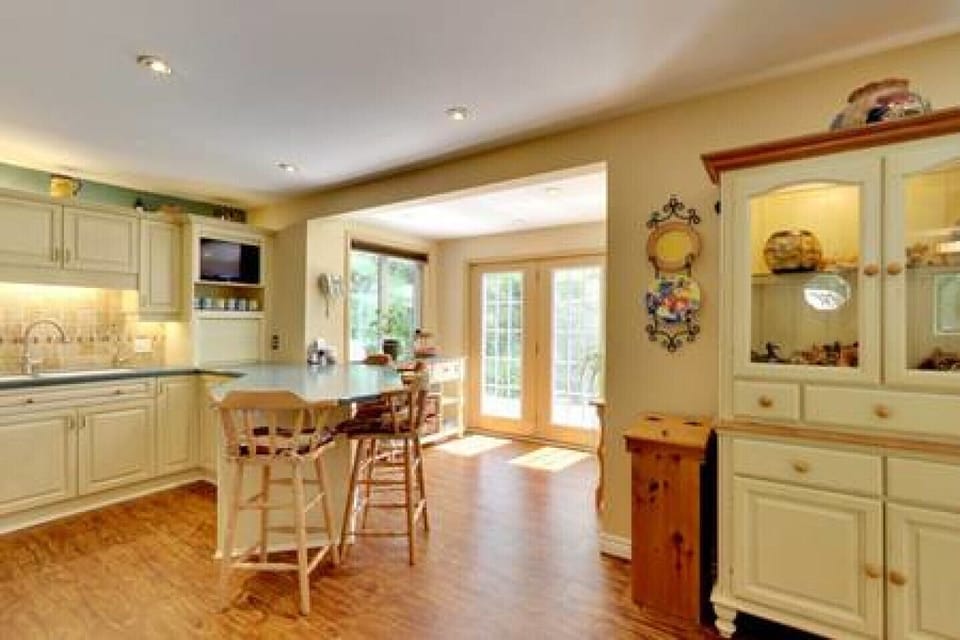 Full kitchen with patio leading to direct propane BBQ and hot tub
