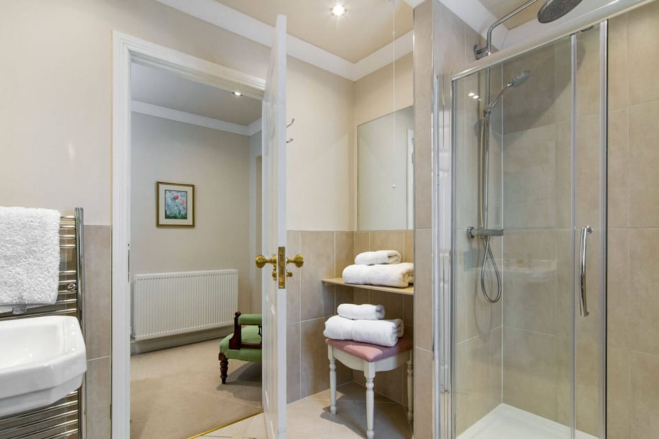 The Gingham Rose large en suite has luxury walk-in double head gas power  shower
