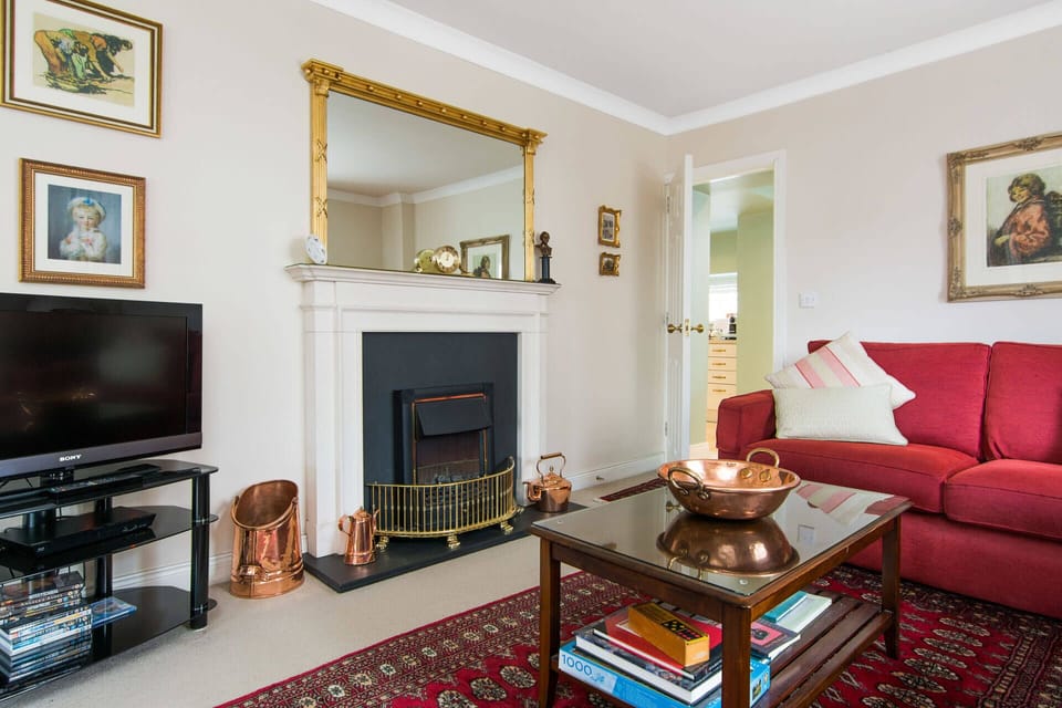The sitting room is appointed with traditional mahogany furniture and antiques. 
