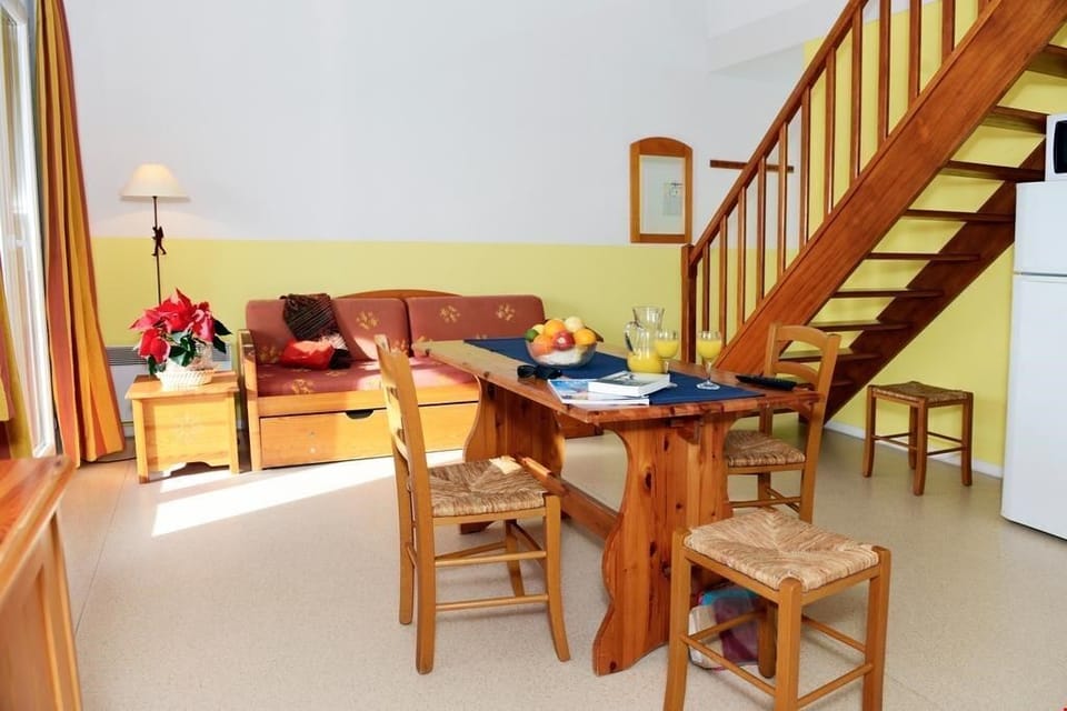 The bright and open living room contains comfortable sofas