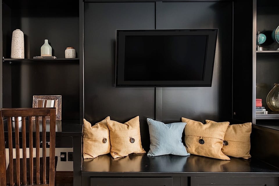 Built-in media nook with plush cushions and sleek cabinetry.