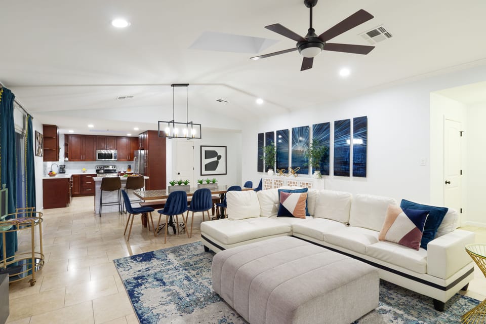 Beautifully designed open floor concept living room featuring comfortable seating, fireplace, and a smart TV.