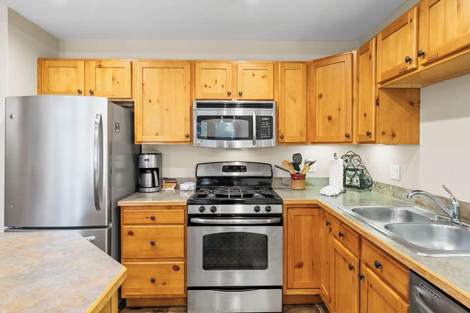 Your fully equipped kitchen features warm wood cabinets, stainless steel appliances, and everything you need to prepare memorable meals during your stay.
