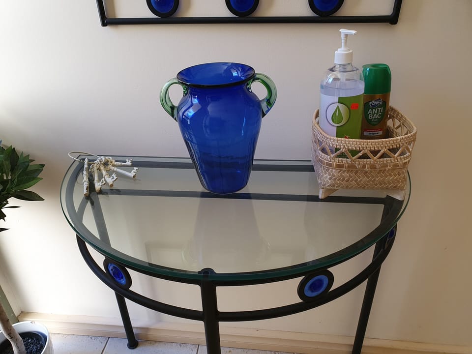 Table at the entrance with hand sanitiser