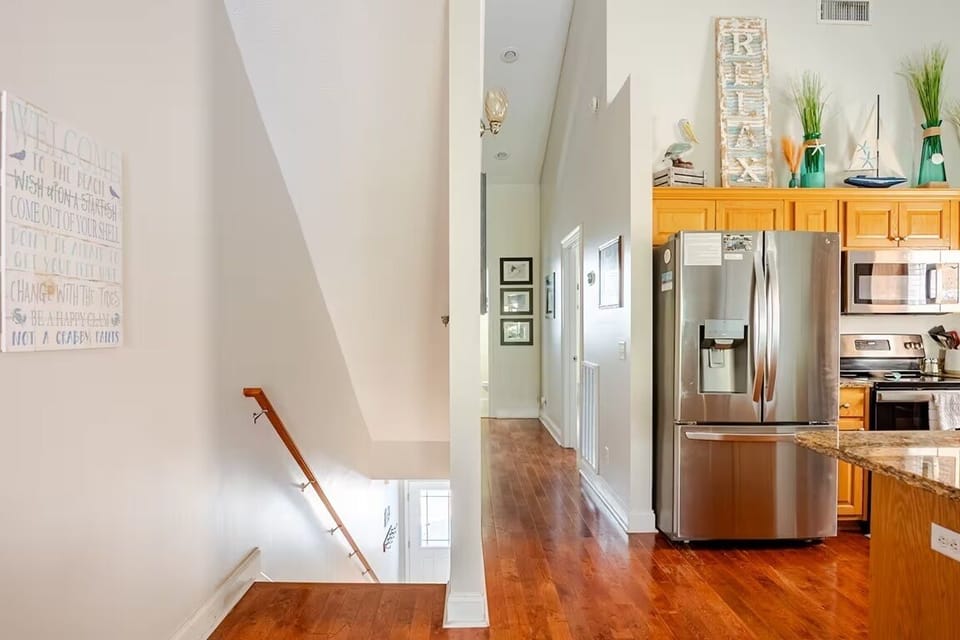 Kitchen Hallway to Master Bedroom.  Stairs down to front door.