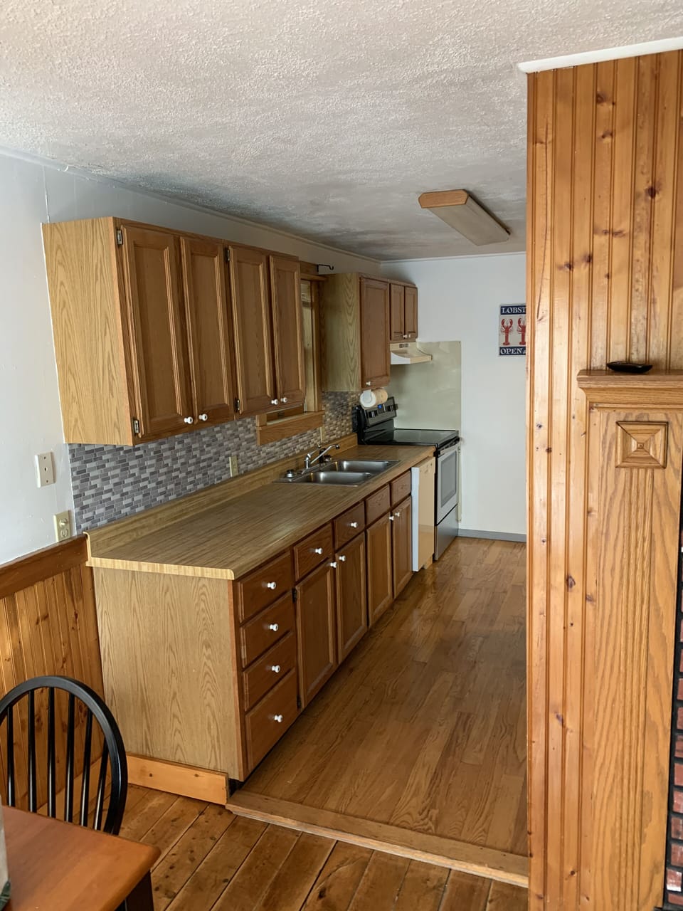 Kitchen area, w/ new stove, fridge, microwave, pans, pots, silverware, ext...