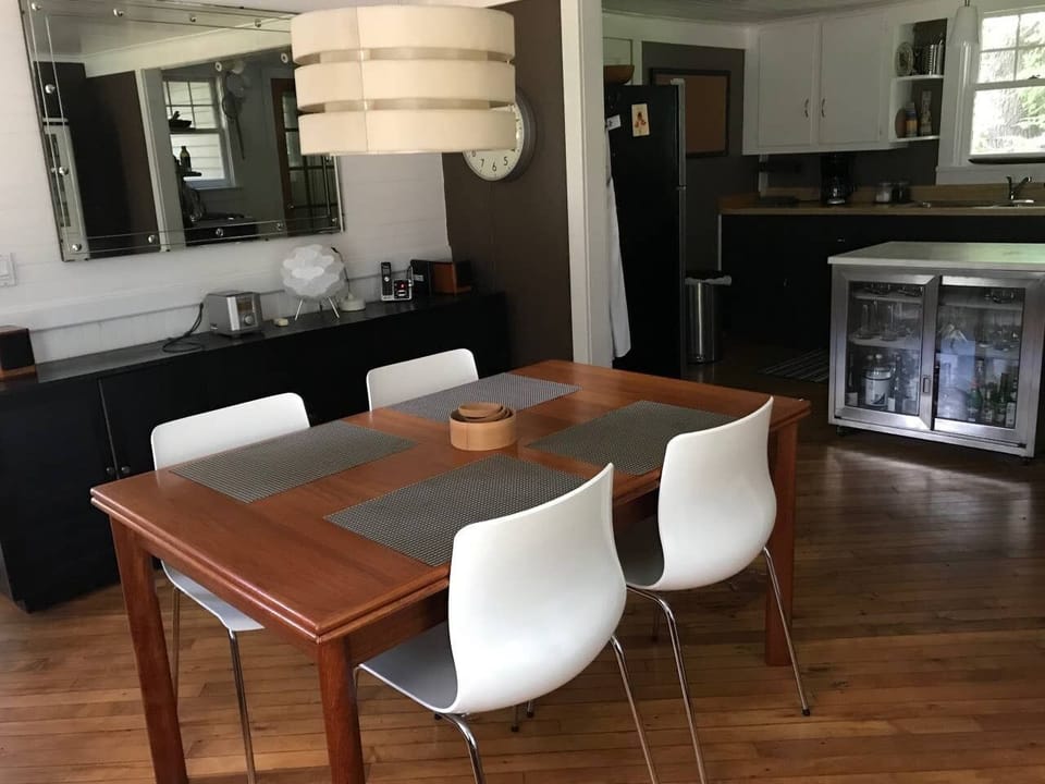 Dining room and kitchen.  Kitchen is well stocked and black cabinet has games. 