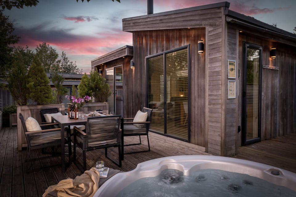 Hot tub, outdoor seating on decking at night  - The Retreat