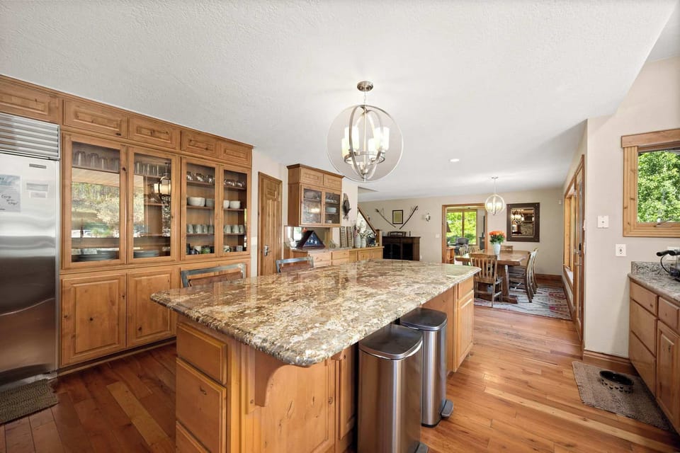 Your dream kitchen awaits with rich wood cabinets, gleaming granite countertops, and space to create memorable meals together.