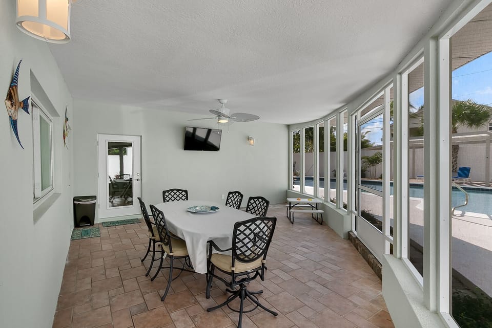 Screen Porch has a view of the pool.