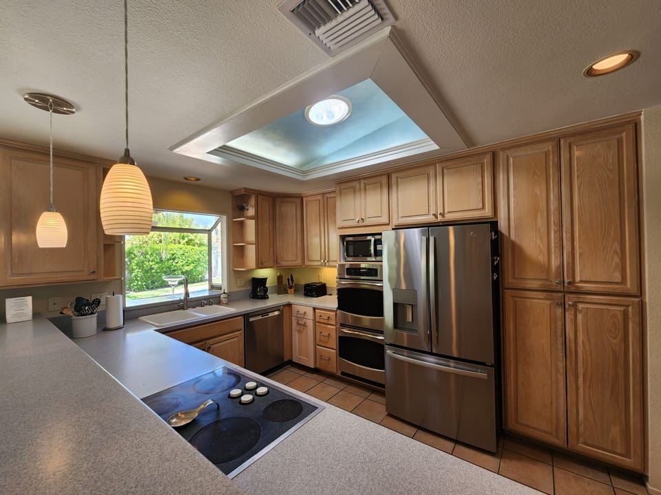 Spacious Kitchen with Stainless Steel Appliances and Garden Window