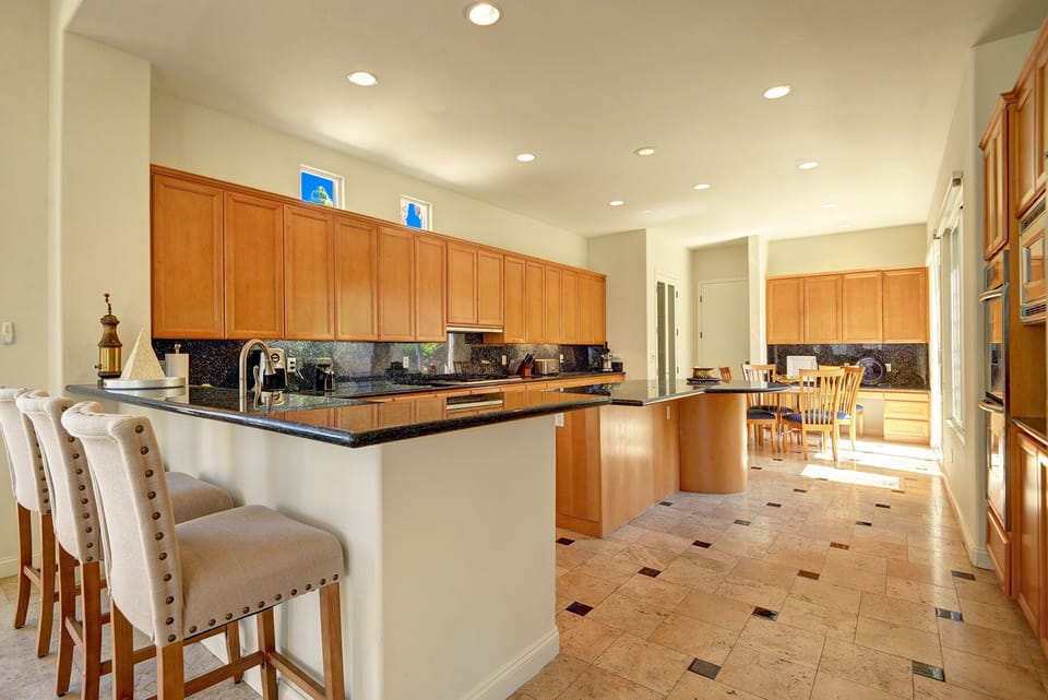 Kitchen with additional bar seating and nook area with desk