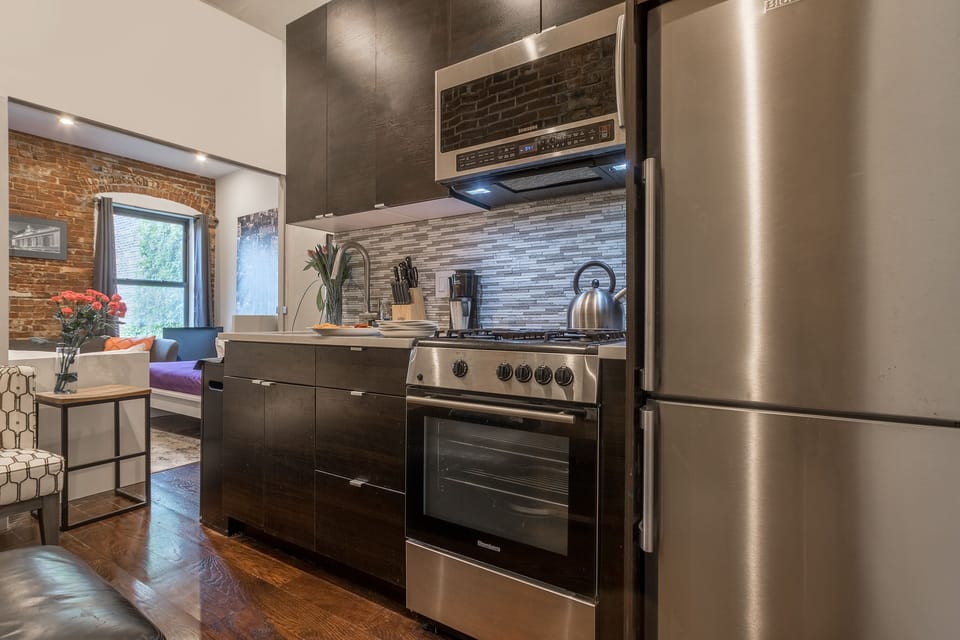 Full sized stainless steel appliances in the kitchen. 